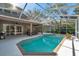 Backyard pool with screened-in enclosure with views of the patio at 5704 Eaglemount Cir, Lithia, FL 33547