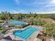 Resort-style pool area with lounge chairs, tennis court and basketball court overlooking a beautiful lake at 5704 Eaglemount Cir, Lithia, FL 33547