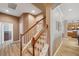 Inviting staircase with wood railings and neutral carpet, leading to the upper level at 5704 Eaglemount Cir, Lithia, FL 33547