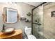 Stylish bathroom featuring a glass-enclosed shower, a vessel sink, and modern wall shelves at 5860 War Admiral Dr, Wesley Chapel, FL 33544