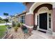 Inviting home entrance featuring decorative landscaping and sidelights at 5860 War Admiral Dr, Wesley Chapel, FL 33544