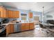 Bright kitchen featuring wood cabinets, modern appliances, and natural light from a window overlooking the breakfast nook at 5860 War Admiral Dr, Wesley Chapel, FL 33544