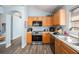 Well-equipped kitchen boasting stainless steel appliances, wood cabinets, and stylish wood flooring at 5860 War Admiral Dr, Wesley Chapel, FL 33544