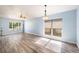 Spacious living room with new flooring, large windows, and recessed lighting at 5860 War Admiral Dr, Wesley Chapel, FL 33544
