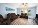 Relaxing living room with modern flooring, comfortable seating, and sliding glass doors at 5860 War Admiral Dr, Wesley Chapel, FL 33544