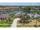 Aerial view of the property showcasing waterfront access, lush landscaping, and neighborhood at 6119 Galleon Way, Tampa, FL 33615