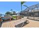 Backyard featuring a screened-in lanai, pool, and dock providing direct access to the water at 6119 Galleon Way, Tampa, FL 33615