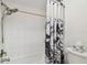 Clean bathroom featuring a tub and shower combination with a patterned shower curtain at 6119 Galleon Way, Tampa, FL 33615