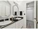 Dual vanity bathroom featuring granite countertops, stylish mirrors, and modern fixtures at 6119 Galleon Way, Tampa, FL 33615