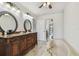 Bright bathroom features a large vanity and soaking tub with sliding glass doors in distance at 6119 Galleon Way, Tampa, FL 33615