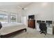 Bright bedroom features a large window with a view and an adjacent home office workspace at 6119 Galleon Way, Tampa, FL 33615