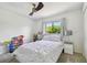Cozy bedroom with a window view, featuring a comfortable bed, side tables, and playful decor at 6119 Galleon Way, Tampa, FL 33615