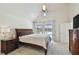Bright bedroom features a large bed, vaulted ceilings and a view of the water at 6119 Galleon Way, Tampa, FL 33615