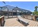 Enjoy the outdoor lifestyle on the deck overlooking the pool and screened in patio at 6119 Galleon Way, Tampa, FL 33615