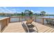 Waterfront deck with lounge chair overlooking the channel and nearby townhomes at 6119 Galleon Way, Tampa, FL 33615