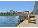 Wooden dock extends over the tranquil water offering a serene spot to relax and enjoy waterfront views at 6119 Galleon Way, Tampa, FL 33615