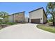 The front exterior of the property features stone accents, lush landscaping, and a driveway at 6119 Galleon Way, Tampa, FL 33615