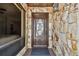 Close up of the front door showcasing stone details, glass accents, and a covered entrance at 6119 Galleon Way, Tampa, FL 33615