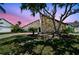 The property's front exterior features a unique stone accent wall and mature landscaping at 6119 Galleon Way, Tampa, FL 33615