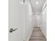 Bright hallway with wood-look flooring and multiple closet doors, providing ample storage at 6119 Galleon Way, Tampa, FL 33615