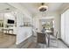 Open kitchen with eat-in area overlooking the living room and outdoor living spaces at 6119 Galleon Way, Tampa, FL 33615