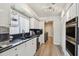 Galley kitchen with stainless appliances, granite counters, and lots of cabinet storage at 6119 Galleon Way, Tampa, FL 33615