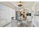 Charming eat-in kitchen featuring white cabinets, stainless steel appliances, and a glass table at 6119 Galleon Way, Tampa, FL 33615