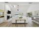 Bright living room with vaulted ceilings, fireplace, and scenic waterfront views through sliding glass doors at 6119 Galleon Way, Tampa, FL 33615