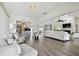 Open-concept living space with modern lighting, and seamless flow into kitchen and dining areas at 6119 Galleon Way, Tampa, FL 33615