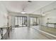 Bright living room features gray floors, mirrored wall and sliding door to the outside at 6119 Galleon Way, Tampa, FL 33615
