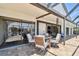 Covered patio featuring a dining table and view of backyard through sliding doors at 6119 Galleon Way, Tampa, FL 33615
