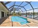 A screened in pool features a lovely view of the adjacent canal at 6119 Galleon Way, Tampa, FL 33615