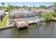 Backyard features a screened-in lanai with a pool, boat dock, and scenic waterfront views at 6119 Galleon Way, Tampa, FL 33615
