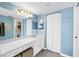 Bathroom with a long white vanity, modern lighting, a large mirror and closet at 6265 Sun Blvd # 605, St Petersburg, FL 33715