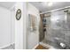 Bathroom features tile shower with glass door, shower caddy, and neutral-toned walls at 6265 Sun Blvd # 605, St Petersburg, FL 33715