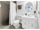 Bathroom with a white toilet, vanity, mirror and shower with curtain at 6265 Sun Blvd # 605, St Petersburg, FL 33715