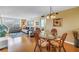 Open condo layout with dining and living areas, highlighted by water views, furnishings, and hardwood floors at 6265 Sun Blvd # 605, St Petersburg, FL 33715