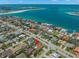 An aerial view shows the home's proximity to the beach with clear blue water at 703 Monte Cristo Blvd, Tierra Verde, FL 33715