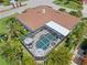 Aerial view featuring a screened-in pool and spa at 703 Monte Cristo Blvd, Tierra Verde, FL 33715