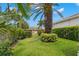 Well maintained backyard with an iron gate leading to another property at 703 Monte Cristo Blvd, Tierra Verde, FL 33715