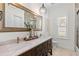 Large bathroom with a double vanity, marble countertop, and elegant mirror at 703 Monte Cristo Blvd, Tierra Verde, FL 33715