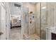 Luxurious bathroom with a glass-enclosed shower and marble tile, adjacent to the primary bedroom at 703 Monte Cristo Blvd, Tierra Verde, FL 33715