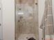Modern bathroom with glass shower, neutral tile, and sleek fixtures at 703 Monte Cristo Blvd, Tierra Verde, FL 33715