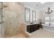Luxurious bathroom boasting a walk-in shower and a freestanding tub for a spa-like experience at 703 Monte Cristo Blvd, Tierra Verde, FL 33715