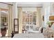 Charming bedroom featuring a serene view of the pool, complemented by stylish furniture at 703 Monte Cristo Blvd, Tierra Verde, FL 33715