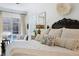 Luxurious main bedroom with a view of the pool, featuring elegant furnishings and decor at 703 Monte Cristo Blvd, Tierra Verde, FL 33715
