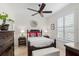Cozy bedroom with a dark wood bed frame, colorful pillows, and bright natural light at 703 Monte Cristo Blvd, Tierra Verde, FL 33715