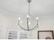 Elegant chandelier with cascading crystals and five candle lights at 703 Monte Cristo Blvd, Tierra Verde, FL 33715