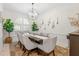 Beautiful dining room features a dark wood table, seating for eight and modern chandelier at 703 Monte Cristo Blvd, Tierra Verde, FL 33715