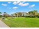Expansive one-story home with lush landscaping and bright blue skies creates a serene tropical oasis at 703 Monte Cristo Blvd, Tierra Verde, FL 33715